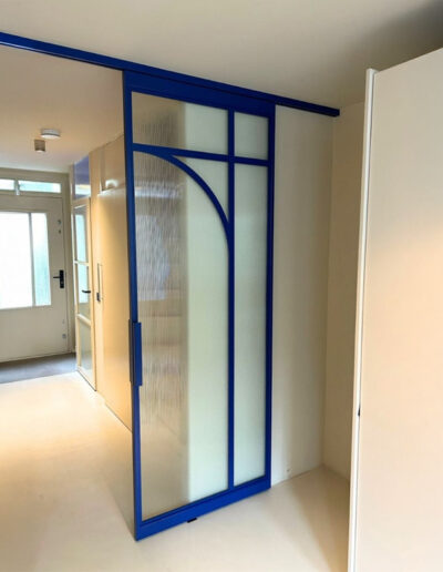 Skygate enkele schuifdeur met blauw ribbelglas, maatwerk in elke gewenste RAL-kleur.