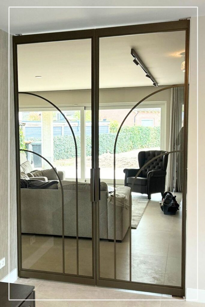 Dubbele stalen taatsdeuren in Metallic Brons met Flow design No. 11 en helder glas van Skygate in een woonkamer