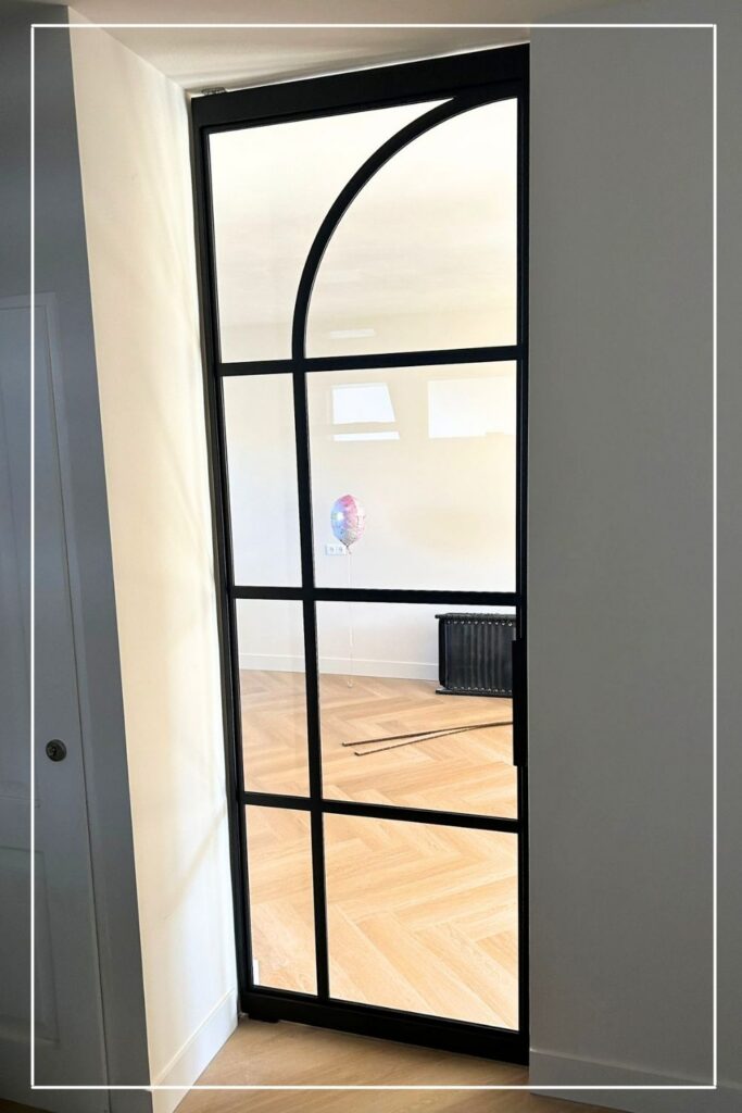 Plafondhoge zwarte stalen taatsdeur met Flow design No. 4 en helder glas van Skygate